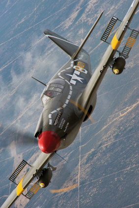 Warbird pilot extraordinaire Dan Friedkin, founder of the Air Force Heritage Flight Foundation, gets in close with his ultra rare A-36A Mustang dive bomber in 27th Fighter Bomber Group livery for the camera of David Leininger.