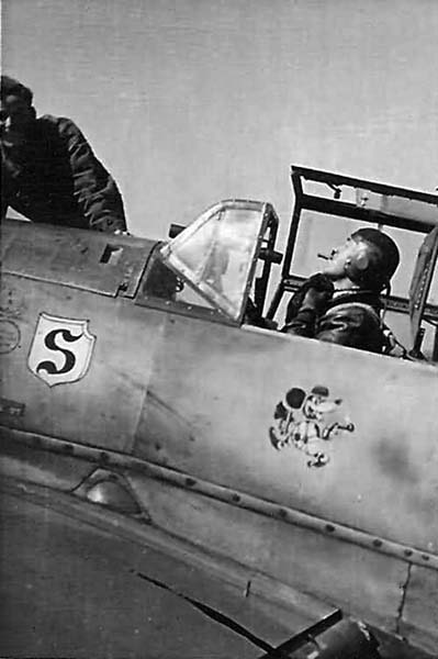 Adolf Galland, Gruppenkommandeur of JG26, in his Bf 109. Note the telescopic sight through the windshield and Galland’s ever-present cigar. (Photo courtesy WorldWarPhotos.com)