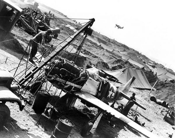 Many of the air bases that supported operations, like this one on Iwo Jima in 1945, were makeshift and exposed crews to enemy fire and the harsh elements. The mechanics and maintenance crews continually worked miracles to keep the fighters flying!