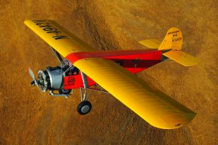 This rare A-6000A, now owned by Yanks Air Museum in Chino, California, soars over the Arizona landscape. You can generally spot any Travel Air product by the shape of its tail and the robust, ready-to-carry-anything airframe. Small airlines like Scenic Airways loved them.