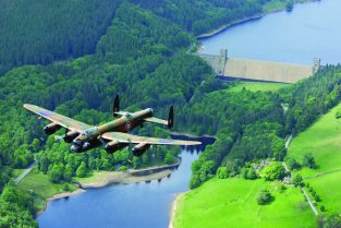 The RAF Battle of Britain Memorial Flight Lancaster PA474 flies over the Derwent Dam, England, in May 2007, on the occasion of the 65th anniversary of the Dams Raid. The Derwent Dam was used by 617 Sqn. in 1943 to train for the Dams Raid. (Photo by John Dibbs/Facebook.com/theplanepicture)