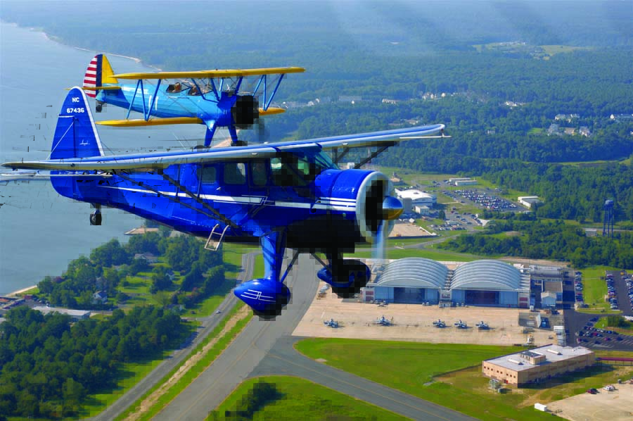 Matt Taylor flies his beautiful 1943 Howard DGA—amusingly nicknamed the “Big Blue Freeloader”—above NAS Patuxent River, Maryland, where he graduated from U.S. Naval Test Pilot School. Shot during NAS Patuxent River’s annual airshow, Matt’s father Larry is on his wing in the Stearman. (Photo by Randy Hepp)