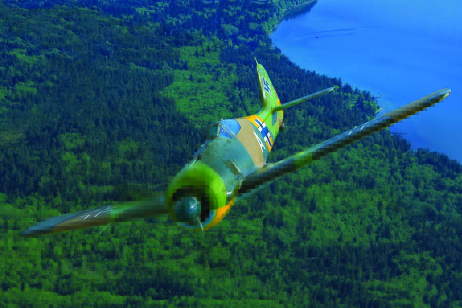 Warbird pilot extraordinaire Steve Hinton flies over the emerald green forest of Everette, Washington in “White A,” which was the sole flying Fw-190 in the world at the time of this shoot. John Dibbs was the only photographer to have been granted an air-to-air photo session with this ultra-rare fighter, which was then owned by Paul Allen and The Flying Heritage & Combat Armor Museum of Washington State.  This airplane and museum are now owned by philanthropist and collector Steuart Walton. (Photo by John Dibbs/Facebook.com/theplanepicture)