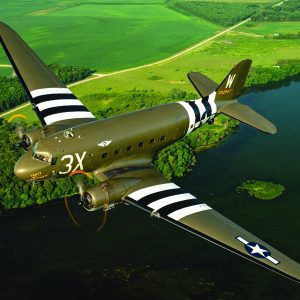 Doug Rozendaal pilots a Douglas C-47 Skytrain owned and operated by the Commemorative Air Force, Central Texas Wing, over the Iowa countryside. Dressed in the scheme of “That’s All, Brother,” the lead aircraft on the D-Day invasion, this C-47 is based out of San Marcos, Texas. (Photo by David Leininger)