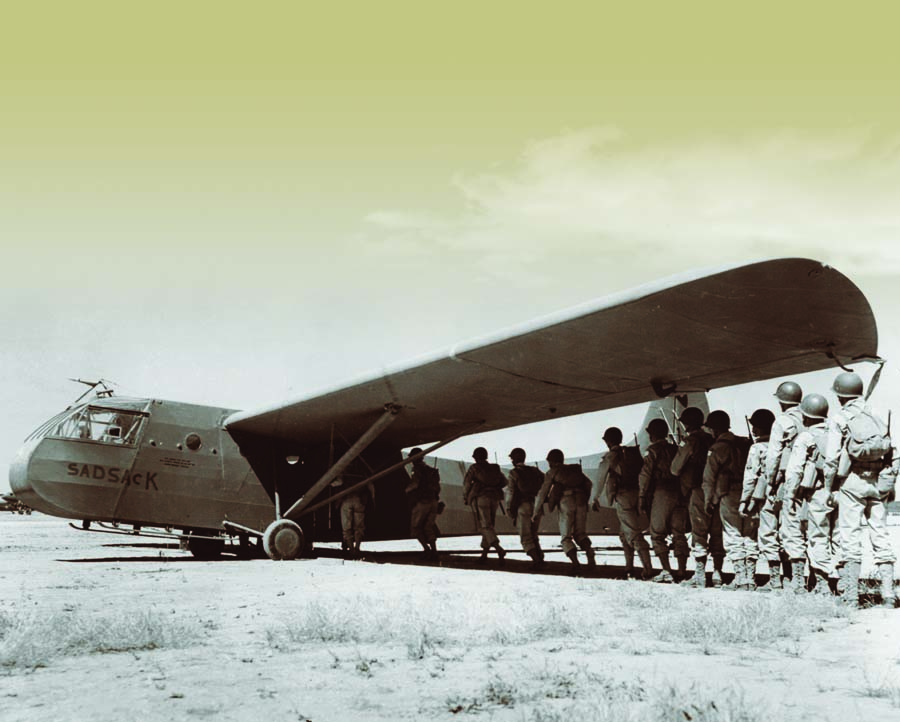 Twelve glider infantrymen of the 193rd Glider Infantry Regiment prepare to climb aboard a Waco CG-4 named “Sad Sack” for a D-Day training mission at Camp MacKall, North Carolina.