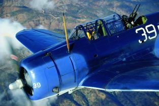 The Planes of Fame SBD-5 Dauntless flies over the California desert with John Maloney at the stick and John Romain manning the twin .50-calibers. This rare dive-bomber is a combat survivor that flew with the Royal New Zealand Air Corps in the South Pacific Russell Islands. (Photo by John Dibbs/Facebook.com/theplanepicturecompany)