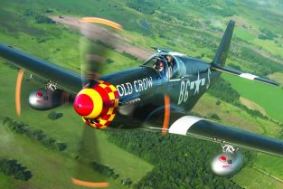 Ray Fowler at the stick in Jim Hagedorn’s P-51D “Old Crow” above Oshkosh, Wisconsin. (Photo by David Leininger)